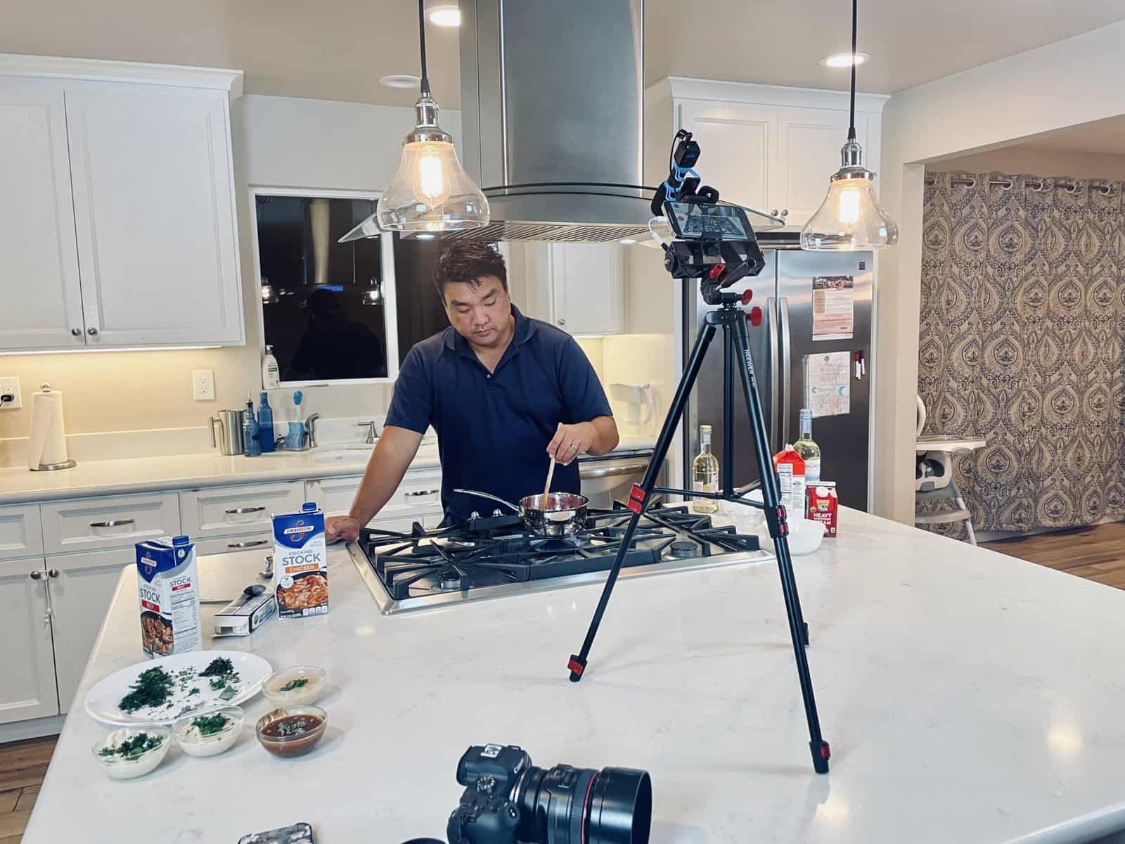 Nathaniel filming a cooking lesson in his home kitchen