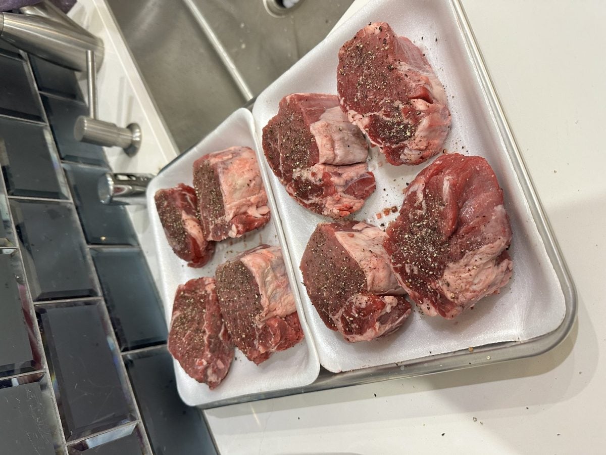 Raw seasoned pork chops in tray