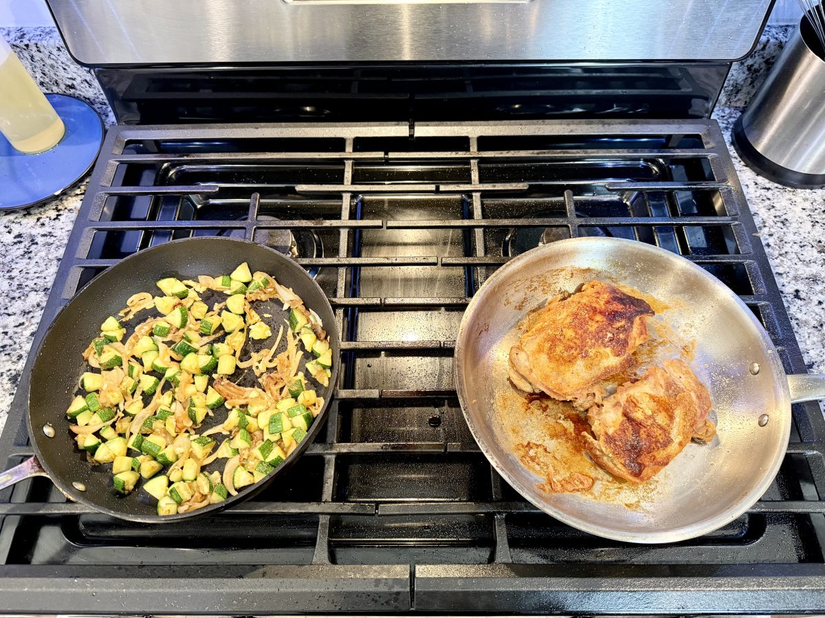 Chicken thighs searing in a single layer with space between every piece